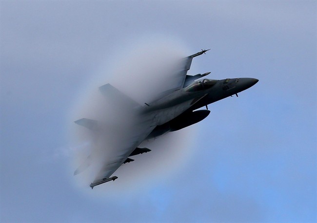 A F18 Super Hornet creates a vapor cone as it flies at a transonic speed. Canada plans to purchase 18 Super Hornet fighter jets on an interim basis before replacing its fleet of aging CF-18 fighter jets.