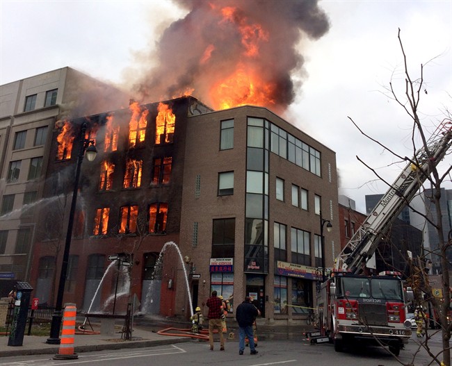 Firefighters battle a blaze in Montreal's Chinatown district at the Robillard building, which once housed Canada's first movie theatre, on Thursday, November 17, 2016.