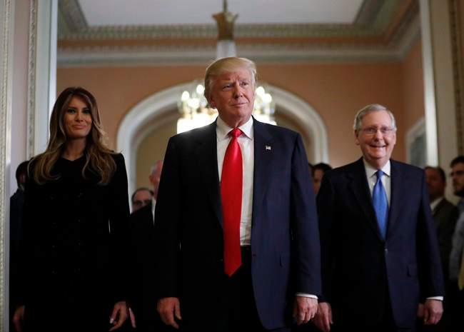 President-elect Donald Trump and his wife Melania walk with Senate Majority Leader Mitch McConnell of Ky. after a meeting on Capitol Hill on Nov. 10, 2016. THE CANADIAN PRESS/AP, Alex Brandon.