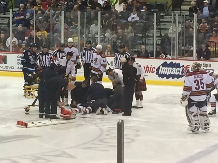 Paramedics work on Tucson Roadrunners captain Craig Cunningham after he collapsed on the ice shortly before the start of Saturday's game against the Manitoba Moose.