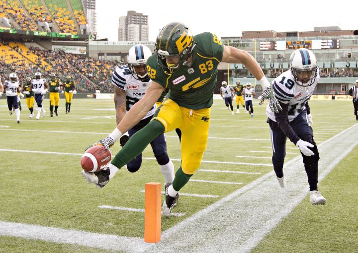 Toronto Argonauts A.J. Jefferson (24) and Devin Smith (19) give chase as Edmonton Eskimos Brandon Zylstra (83) reaches in for the touchdown during first half CFL action in Edmonton, Alta., on Saturday November 5, 2016. 