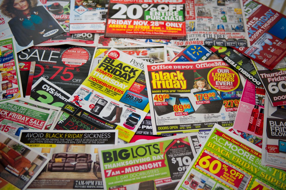 A kitchen table full of "Black Friday" Sale Circulars with Sale Promotions from various Retailers.