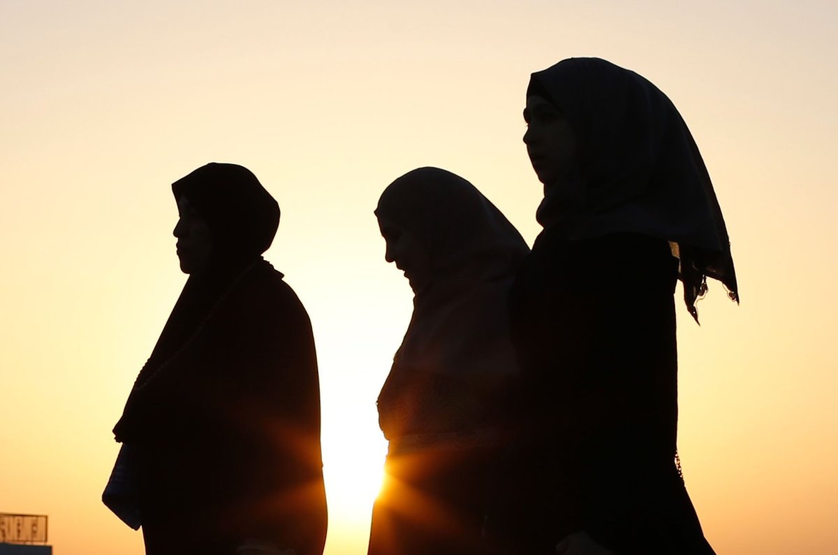 A silhouette of Muslim women.