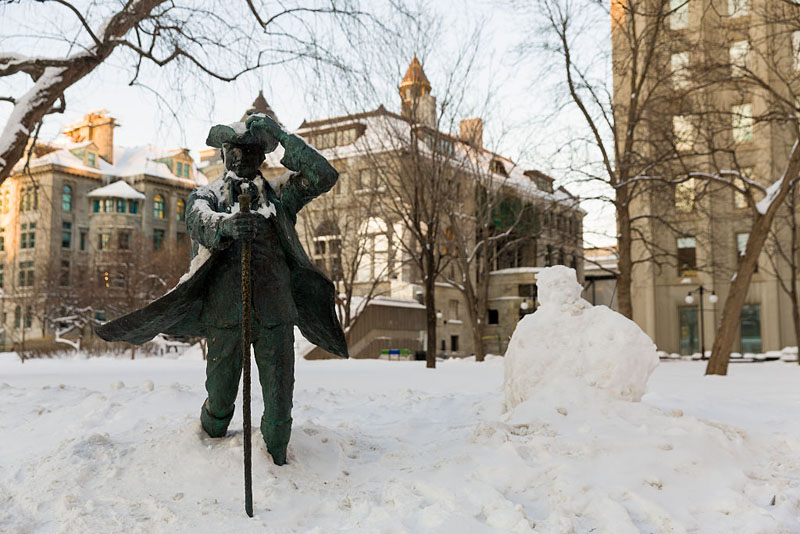 A statue of James McGill, founder of McGill University, is seen beside a snowman. Post-secondary schools across the country have seen a rise in applications from U.S. students.
