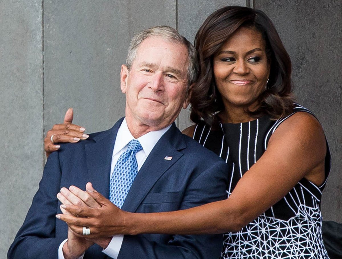 Former US President George W. Bush receives a hug from US First Lady Michelle Obama in September, 2016. 