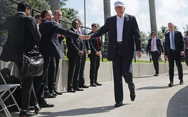 Republican presidential nominee Donald Trump gives a fist bump to Republican National Committee Chairman Reince Priebus during a campaign rally at Bayfront Park Amphitheater November 2, 2016 in Miami, Florida. 