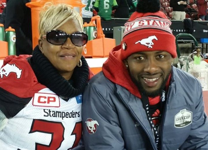 Renee Hill wearing her sons' jersey along the sidelines at the 104th Grey Cup. (Osagie Odiase right).