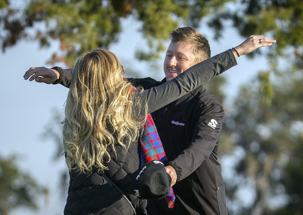 Mackenzie Hughes, of Canada, right, hugs his wife, Jenna, after winning the playoff round at the RSM Classic golf tournament, Monday, Nov. 21, 2016, in St. Simons Island, Ga. (AP Photo/Stephen B. Morton)