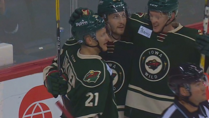 The Iowa Wild celebrate an overtime victory on Tuesday at MTS Centre.