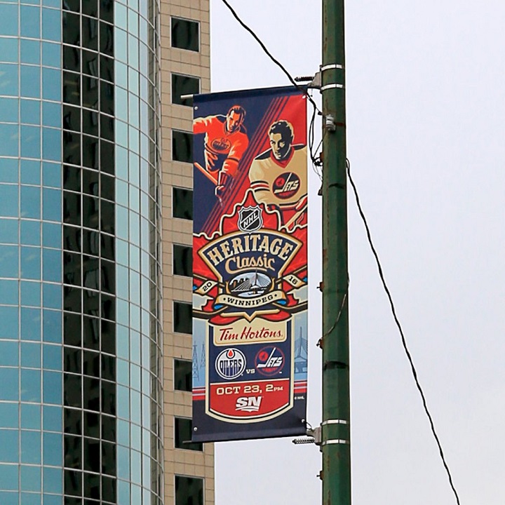 The Winnipeg Jets are auctioning off a dozen Heritage Classic banners in support of CancerCare Manitoba.
