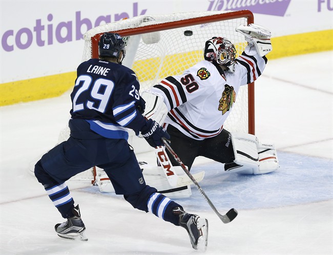 Winnipeg Jets' Patrik Laine scores on Chicago Blackhawks goaltender Corey Crawford during third period of a NHL game in Winnipeg on November 15, 2016.