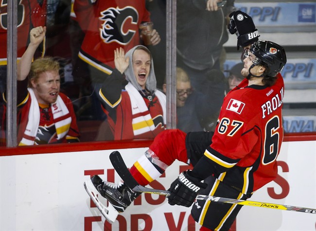 Calgary Flames' Michael Frolik, from the Czech Republic, celebrates his game-winning overtime goal against the Arizona Coyotes during an NHL hockey game in Calgary, Wednesday, Nov. 16, 2016.