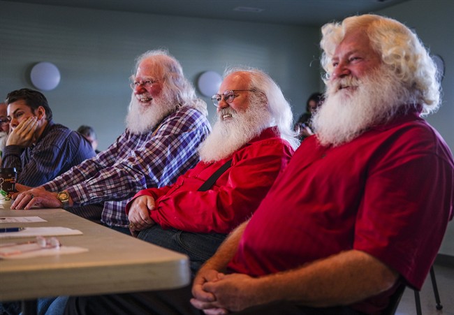 In this file photo Santa Clauses Bob Slocombe, left, Dan Dickison, centre, and Jeff Badyk listen to instructors at Santa School in Calgary, Alta., Friday, Oct. 21, 2016.