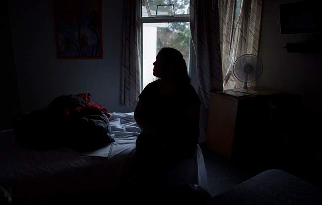 A mother from British Columbia, who can't be identified, poses for a photo in Vancouver, B.C., on Wednesday, Nov. 9, 2016. The British Columbia Ministry of Children and Family Development seized the woman's two children last month, for the second time, because of unexplained breaks in her son's legs. Since he was a baby, he has suffered at least a dozen broken bones.