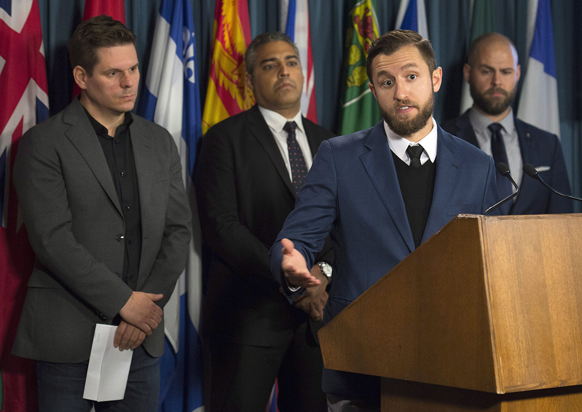 La Presse journalist Patrick Lagace (left), journalist Mohamed Fahmy, and Executive Director of Canadian Journalists for Free Expression Tom Henheffer (right) listen to VICE News journalist Ben Makuch speak about his experiences during a news conference on police surveillance and greater protection for journalists in Ottawa, Wednesday November 16, 2016.