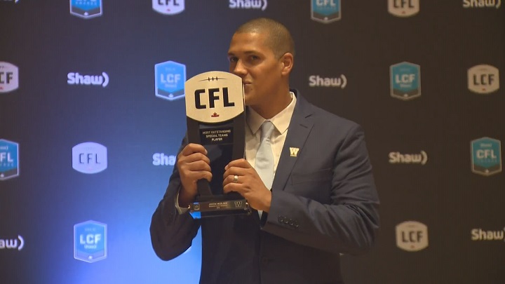 Blue Bombers kicker Justin Medlock kisses his award for Most Outstanding Special Teams Player.