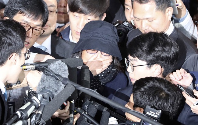 In this Monday, Oct. 31, 2016 photo, Choi Soon-sil, center, who is at the center of a political scandal, is surrounded by media upon her arrival at the Seoul Central District Prosecutors’ Office in Seoul, South Korea.