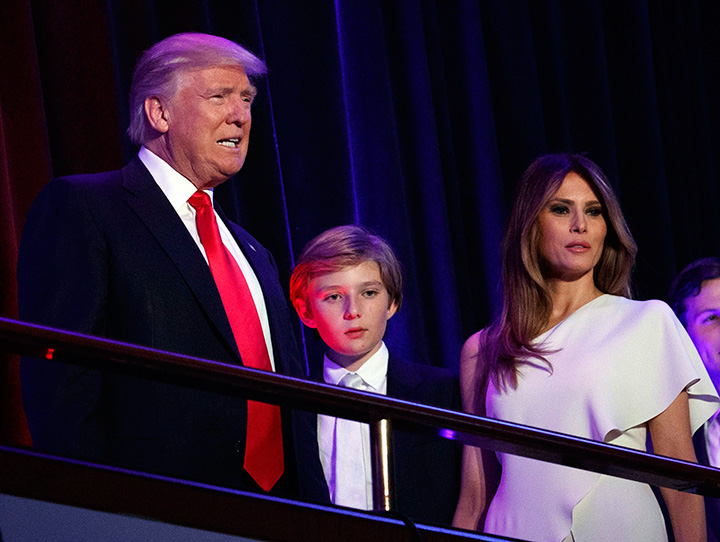 In this Nov. 9 2016 file photo, President-elect Donald Trump arrives to speak at an election night rally with his son Barron and wife Melania, in New York. 