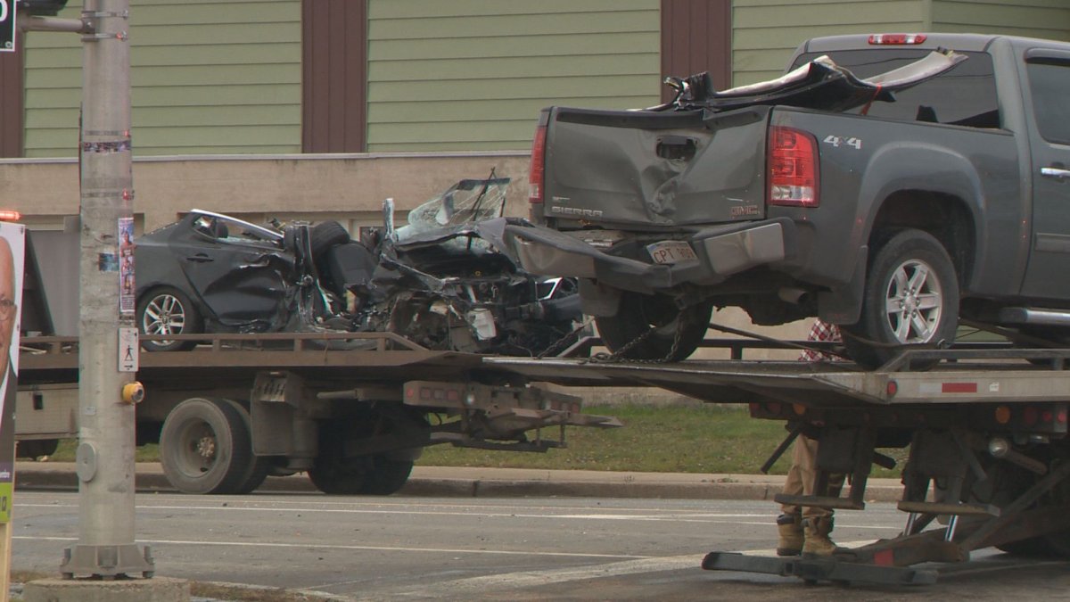 Two vehicles are removed from the scene of a fatal crash in Moncton, N.B. A 66-year-old Moncton man is dead and 34-year-old Moncton woman has been charged with impaired driving causing death.