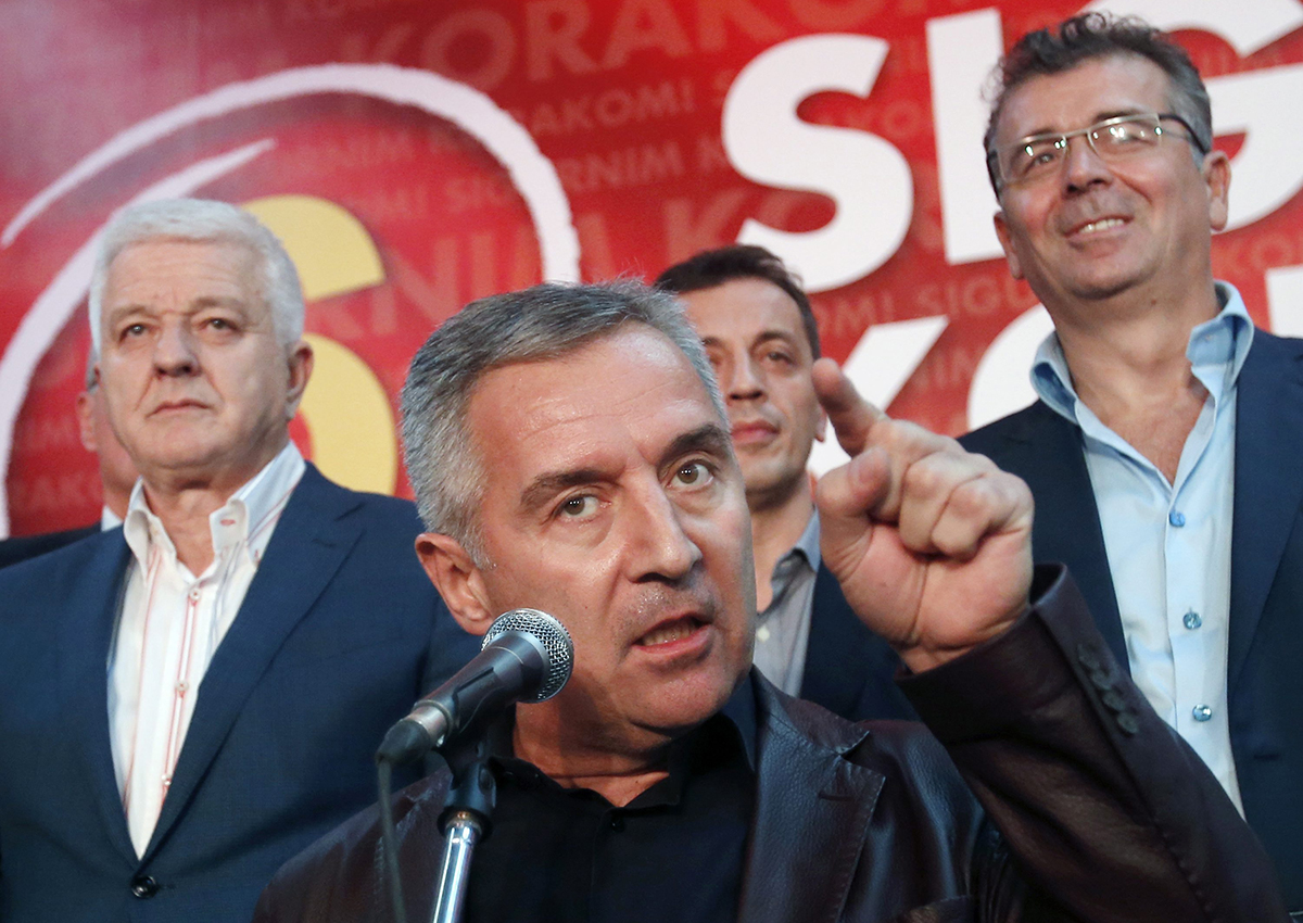 Montenegro's Prime Minister and long-ruling Democratic Party of Socialists leader Milo Djukanovic, center, speaking in his party headquarters, in Podgorica, Montenegro. 