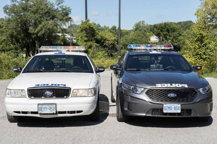 A side-by-side view of Toronto police cruisers with the old design (left) and the newer design (right). Officers are asking for feedback on the design of the service's vehicles after the rollout of the dark grey design was halted in 2016 due to criticism.