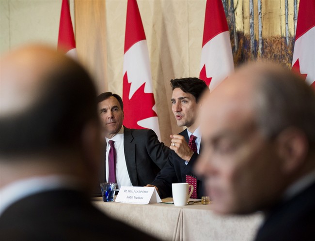 Prime Minister Justin Trudeau, back right, and Finance Minister Bill Morneau, back left, participate in a infrastructure round table in Toronto, Nov. 14, 2016.