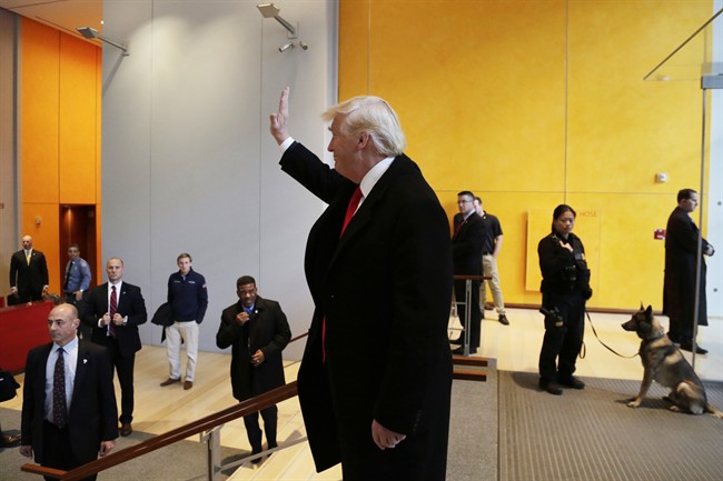 President-elect Donald Trump waves to a crowd in the lobby of the New York Times building following a meeting, Tuesday, Nov. 22, 2016, in New York. (AP Photo/Mark Lennihan).