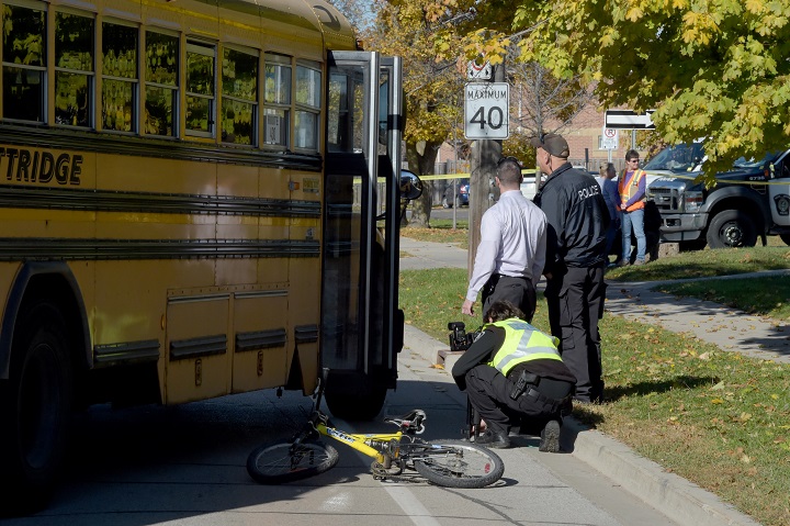 Halton police investigate the scene of collision between a cyclist and a school bus in Oakville on Nov, 7, 2016.