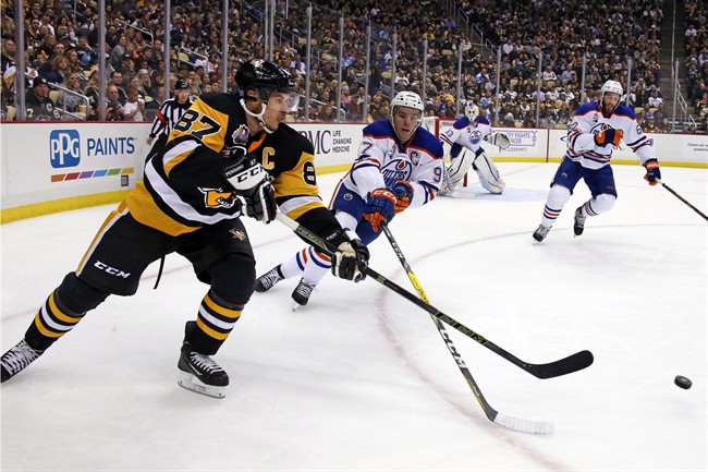 Pittsburgh Penguins' Sidney Crosby (87) gets off a pass in front of Edmonton Oilers' Connor McDavid (97) during the second period of an NHL hockey game in Pittsburgh, Tuesday, Nov. 8, 2016.