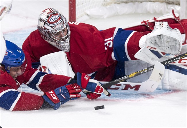 Montreal Canadiens defenceman Shea Weber helps goalie Carey Price.