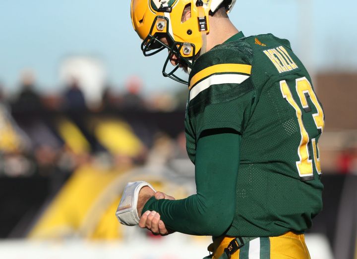 Edmonton Eskimos quarterback Mike Reilly (13) holds his wrist while walking off the field during the second-half of CFL eastern semi-final football action against the Hamilton Tiger Cats, in Hamilton, Ont., on Sunday, November 13, 2016. 