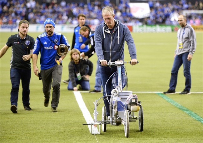 The grounds crew make last minute adjustments delaying the start of the first leg of the MLS Eastern Conference final with the Montreal Impact facing the Toronto FC at the Olympic Stadium Tuesday, November 22, 2016 in Montreal. 