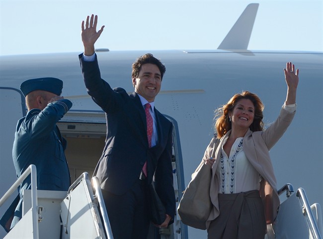 Prime Minister Justin Trudeau and his wife Sophie Gregoire-Trudeau wave before departing Ottawa for Cuba on Tuesday, Nov. 15, 2016.