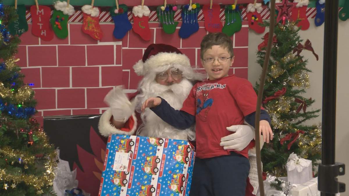 A child tells Santa what he wants for Christmas at the Generations Foundation Food and Toy Drive.