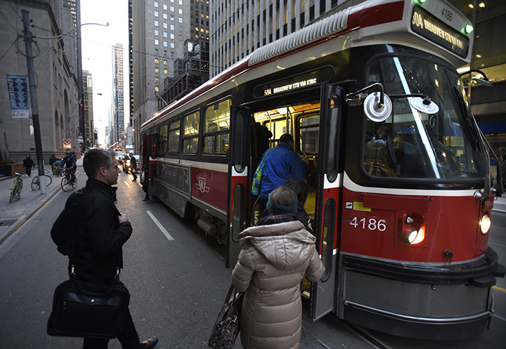 Commuters board an eastbound King St. streetcar at Yonge St. on Dec 8 2014. 