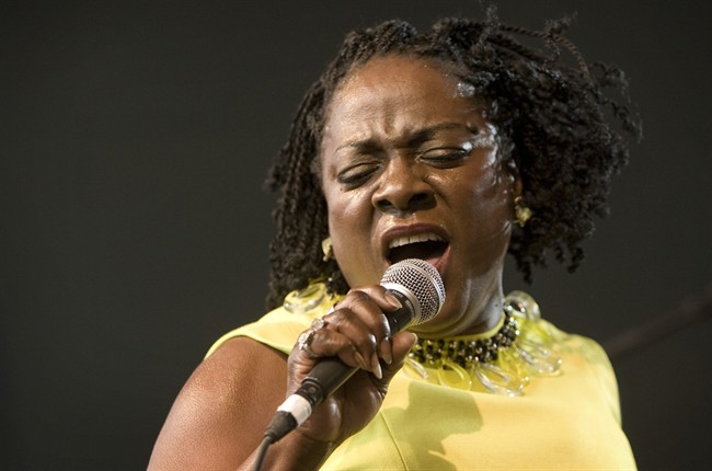 In this March 19, 2010 file photo, Sharon Jones and the Dap-Kings perform at the SPIN Party at Stubb's during the South by Southwest music festival in Austin, Texas. Jones, a big-voiced soul singer who performed with high energy onstage has died at age 60 in New York, after battling pancreatic cancer. Her representative Judy Miller Silverman says she died Friday, Nov. 18, 2016, at a Cooperstown hospital surrounded by her band, the Dap-Kings.
