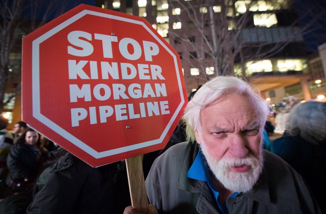 Paul George holds a sign during a protest against the Kinder Morgan Trans Mountain Pipeline expansion project, in Vancouver, B.C., on Tuesday November 29, 2016.