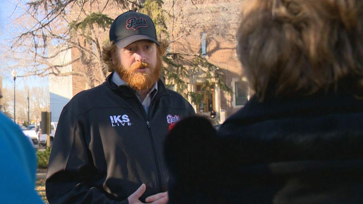 Photographer Chris Harris discusses his project with visitors to his installation.
