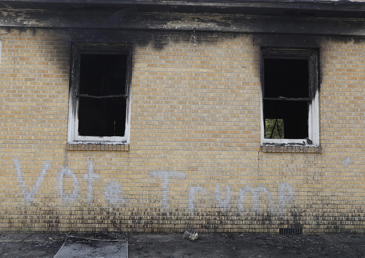 "Vote Trump" is spray painted on the side of the fire damaged Hopewell M.B. Baptist Church in Greenville, Miss., Wednesday, Nov. 2, 2016.  