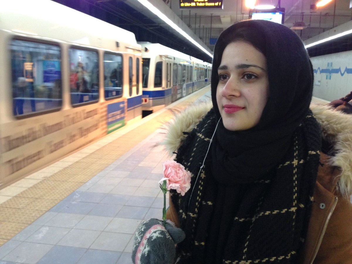 Tehseenah Zahrah, a psychology student at the University of Alberta, was handed a carnation at the LRT platform on Wednesday, Dec. 7, 2016.