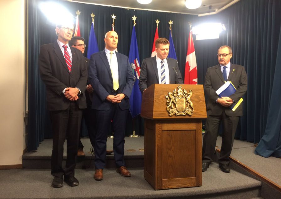 David Swann, Greg Clark, Brian Jean and Ric McIver at a news conference on Dec. 13, 2016.