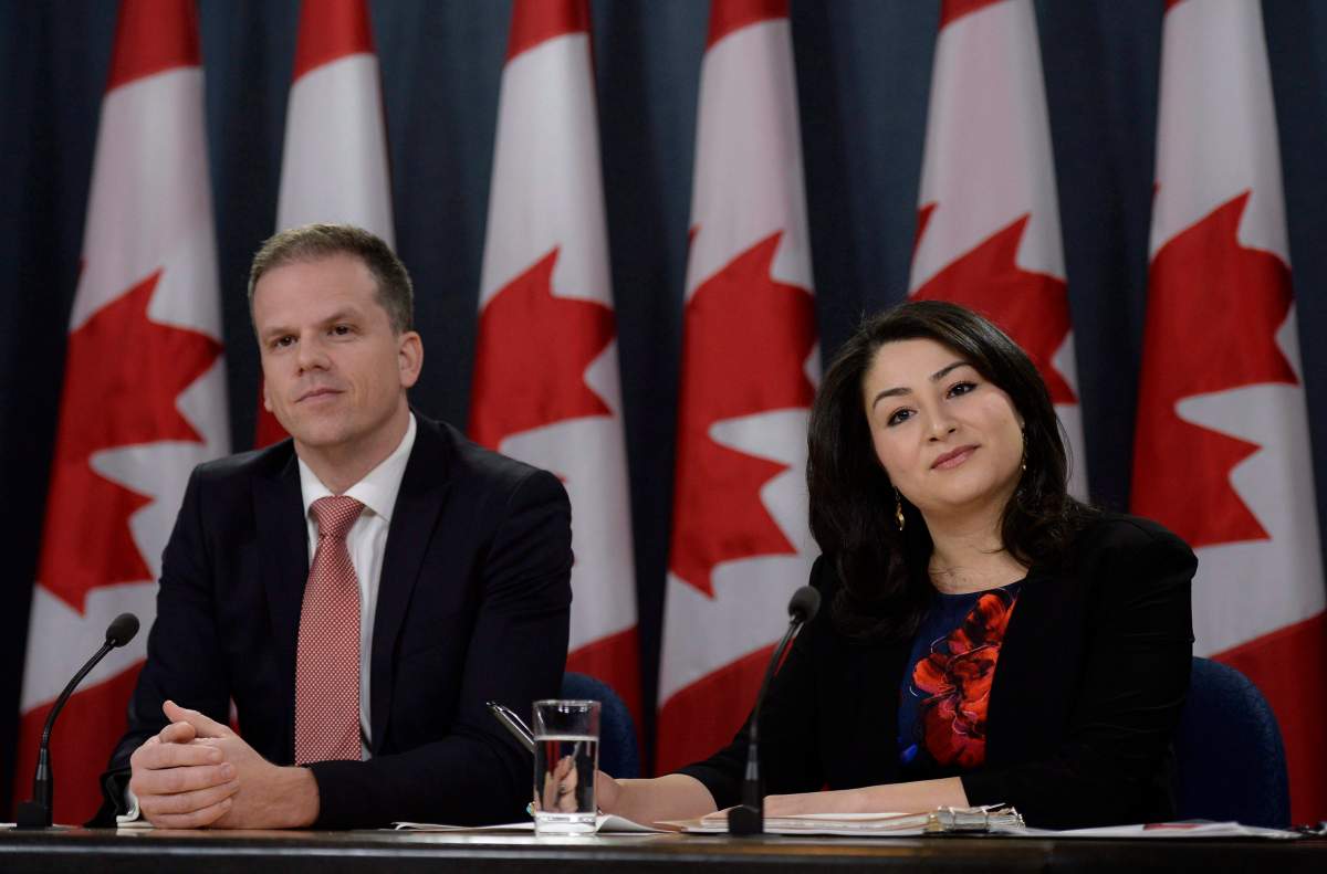Minister of Democratic Institutions Maryam Monsef (right) and Parliamentary Secretary to the Minister of Democratic Institutions Mark Holland listen to a question during a press conference, on Thursday, Nov. 24, 2016 in Ottawa. 