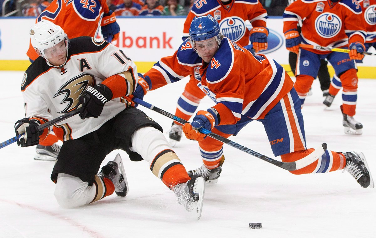 Anaheim Ducks' Corey Perry (10) and Edmonton Oilers' Kris Russell (4) battle in front of the net during third period NHL action in Edmonton, Alta., on Saturday, December 3, 2016. THE CANADIAN PRESS/Jason Franson.