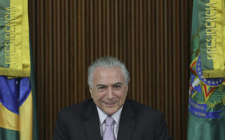 Brazil's President Michel Temer smiles during a pension plan proposal to National Congress leaders, at the Planalto Presidential Palace, in Brasilia, Brazil, Monday, Dec. 5, 2016. 