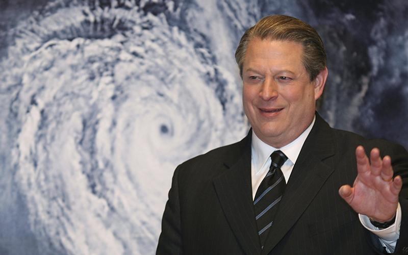 Former Vice President Al Gore acknowledges spectators in front of a poster of his starring documentary film "An Inconvenient Truth" on global warming before its screening during the Japan Premier at a theater in Tokyo. 