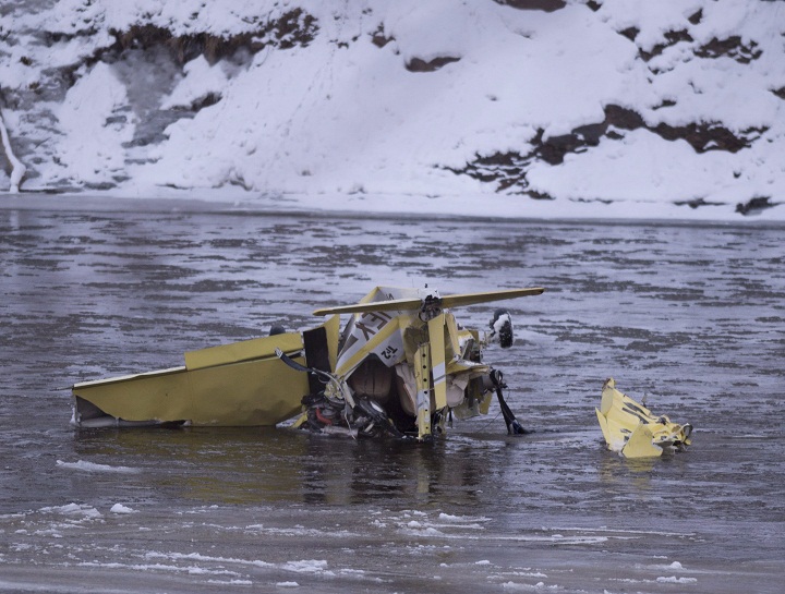 A Grumman American AA-1 aircraft lies in the middle of the Etchemins River Saturday, December 10, 2016 in Levis Que. The plane crashed after it hit power lines. Two people were on board and were evacuated by ambulance. 