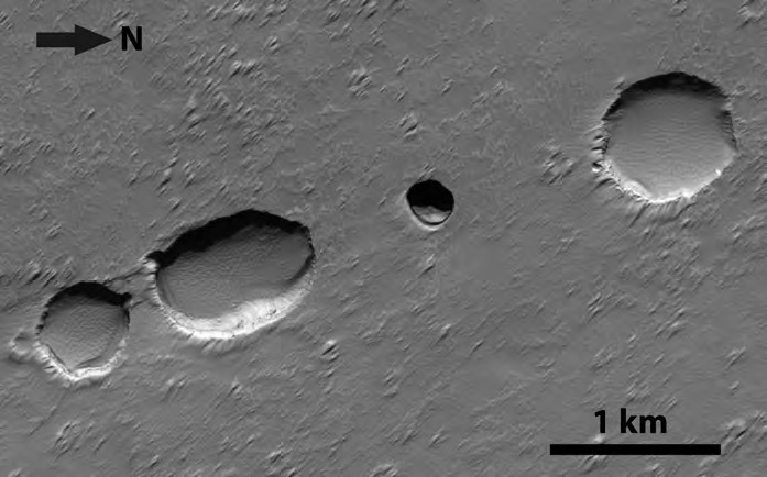 These dark circles are ‘skylights’ that opened when parts of an underground lava tube collapsed on Mars. Tubes like this one may be a possible home for humans arriving on the planet.