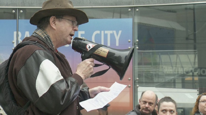 Tom Page, a volunteer for BC ACORN, an advocacy group, addresses people who gathered in downtown Vancouver on Saturday, Dec. 3, 2016 to raise awareness of their concerns that there is inadequate government support for people living with disabilities.