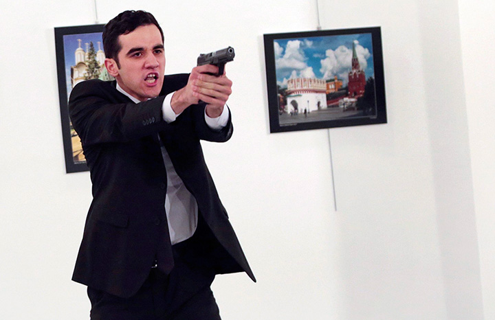 An unnamed gunman gestures after allegedly shooting the Russian Ambassador to Turkey, Andrei Karlov, at a photo gallery in Ankara, Turkey on Monday, Dec. 19, 2016. 