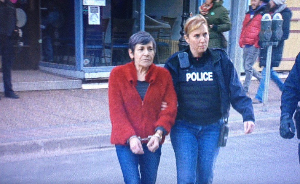 Shirley Martineau, owner of Auntie's Health and Wellness, is lead out of her marijuana dispensary in handcuffs on Dec. 30. 